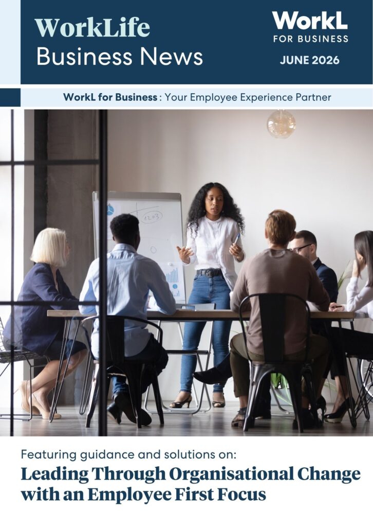 Cover of WorkLife Business News for WorkL for Business, June 2026. The full vertical layout features a central image of a woman presenting to colleagues around a conference table. Text at the bottom reads: "Featuring guidance and solutions on: Leading Through Organisational Change with an Employee First Focus."
