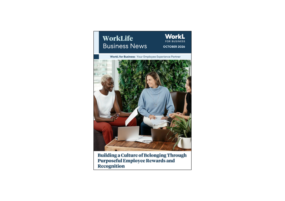 Three diverse colleagues sitting together on a couch around a coffee table in a modern office, collaborating on documents titled WorkLife Business News.